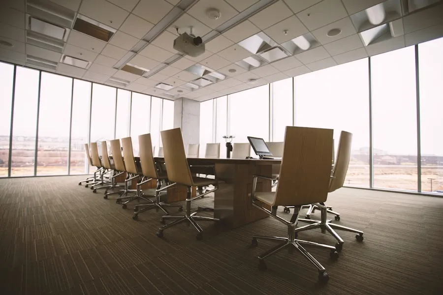 Modern conference room with a long table and panoramic city-view windows